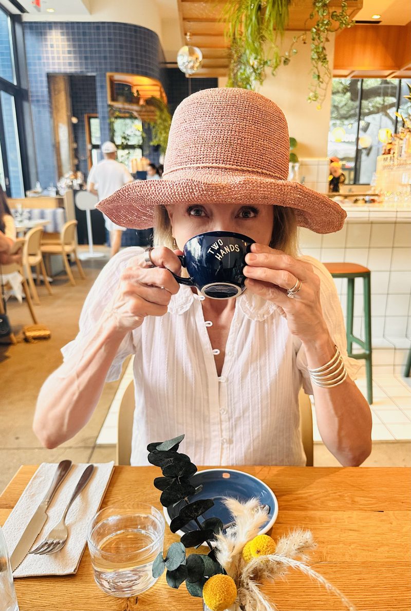 Rhonda Evans drinking coffee at Two Hands in Austin, Texas.